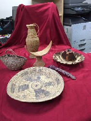 Bowls and a vase or jug on a red cloth