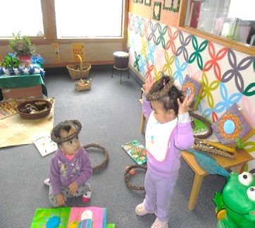 This is a photo of two children wearing head dress