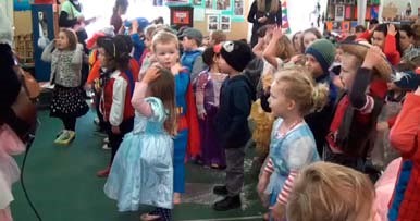 Several dozen children dressed up in a variety of costumes