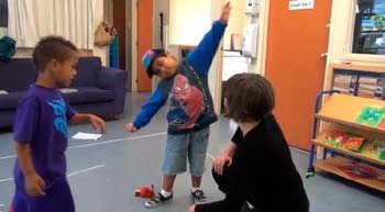 A photo of a boy pretending to be an aeroplane