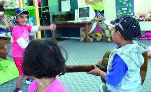 A picture of a child doing the haka, while others watch