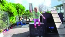 This is a picture of quite a young child jumping off a box that's about their height