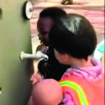 This is a picture of two children in front of a tap, which is twisted to one side