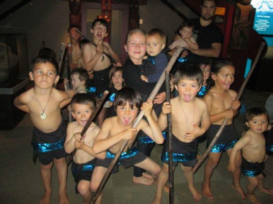 A photo of about 20 young boys preparing to do the haka