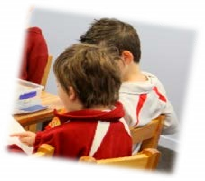 A photo of two children reading a book together