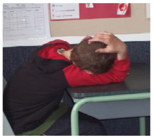 A boy with his head on the desk