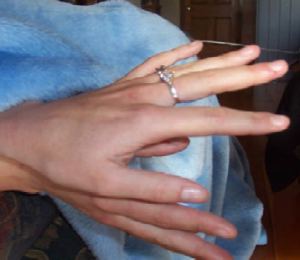 A photo of teacher displaying their engagement ring (possibly)