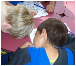 Two boys with their heads lying down on the desk