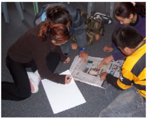 Four students sitting on the floor working on a problem