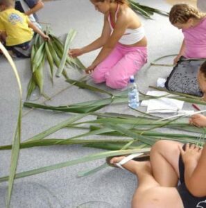 Kids weaving flax together