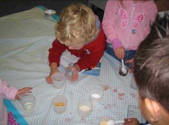 A student is focusing on some containers (which may have liquid inside them).