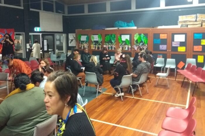 This is a picture of about 20 people in a community hall