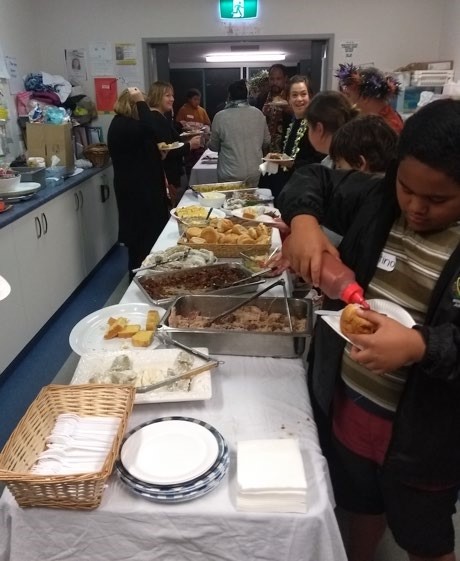 This is a photo of about a dozen people in a community kitchen