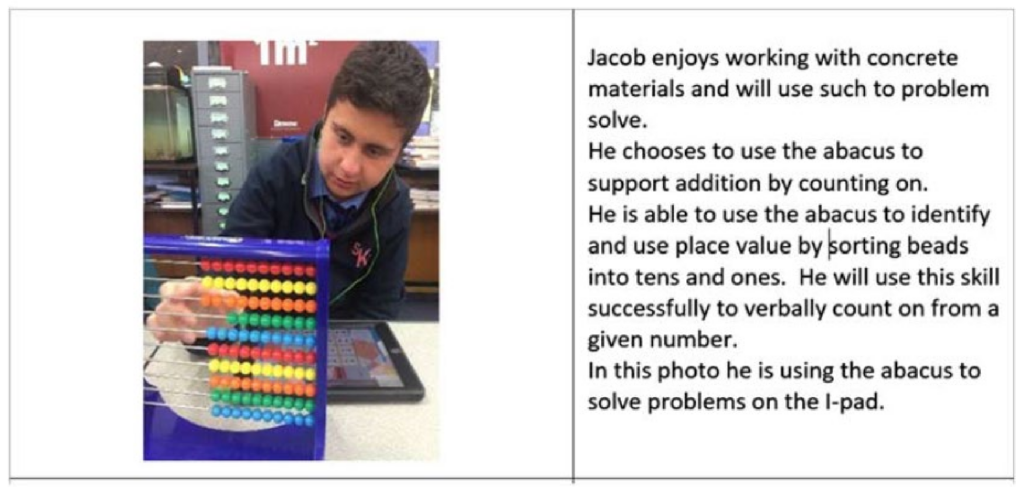 Jacob is pictured in front of an abacus. He enjoys working with concrete materials and will use such to problem solve. He chooses to use the abacus to support addition by counting on. He is able to use the abacus to identify and use place value by sorting beads into tens and ones. He will use this skill successfully to verbally count on from a given number. In this photo, he is using the abacus to solve problems on the iPad.