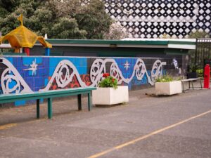 Koru pattern at newmarket school in the outdoor concrete areas with park benches